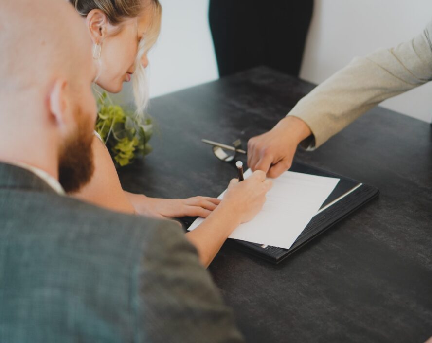 woman signing a document