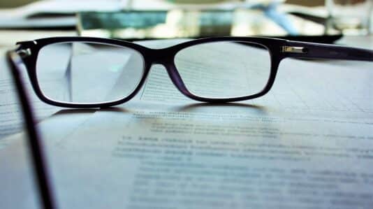 eyeglasses on top of a contract agreement