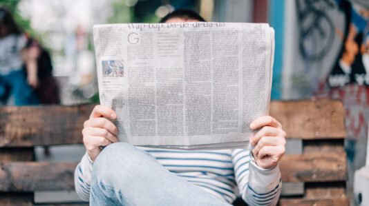 Person reading newspaper