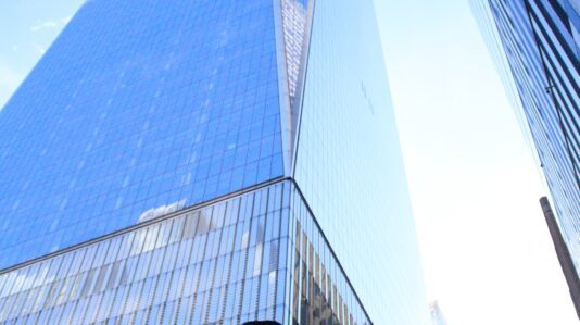 man looking up in a high-rise building