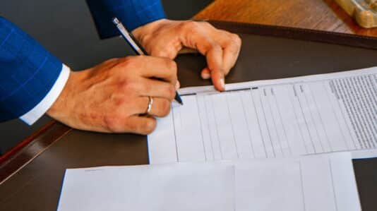 person signing a document