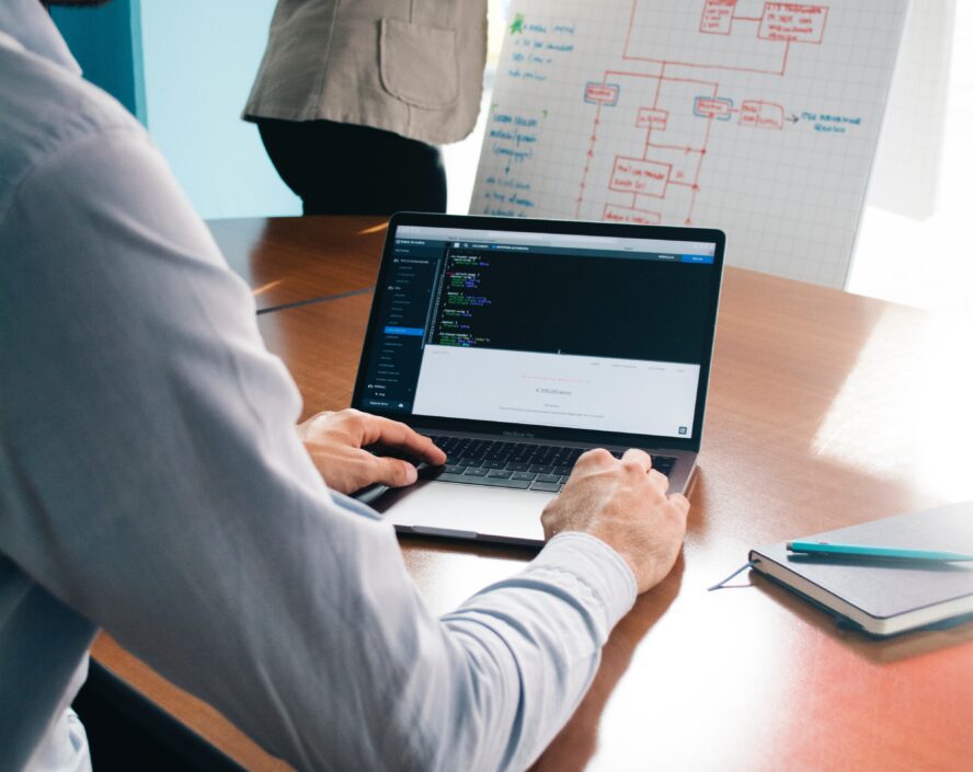 man using notebook device and woman doing a graph
