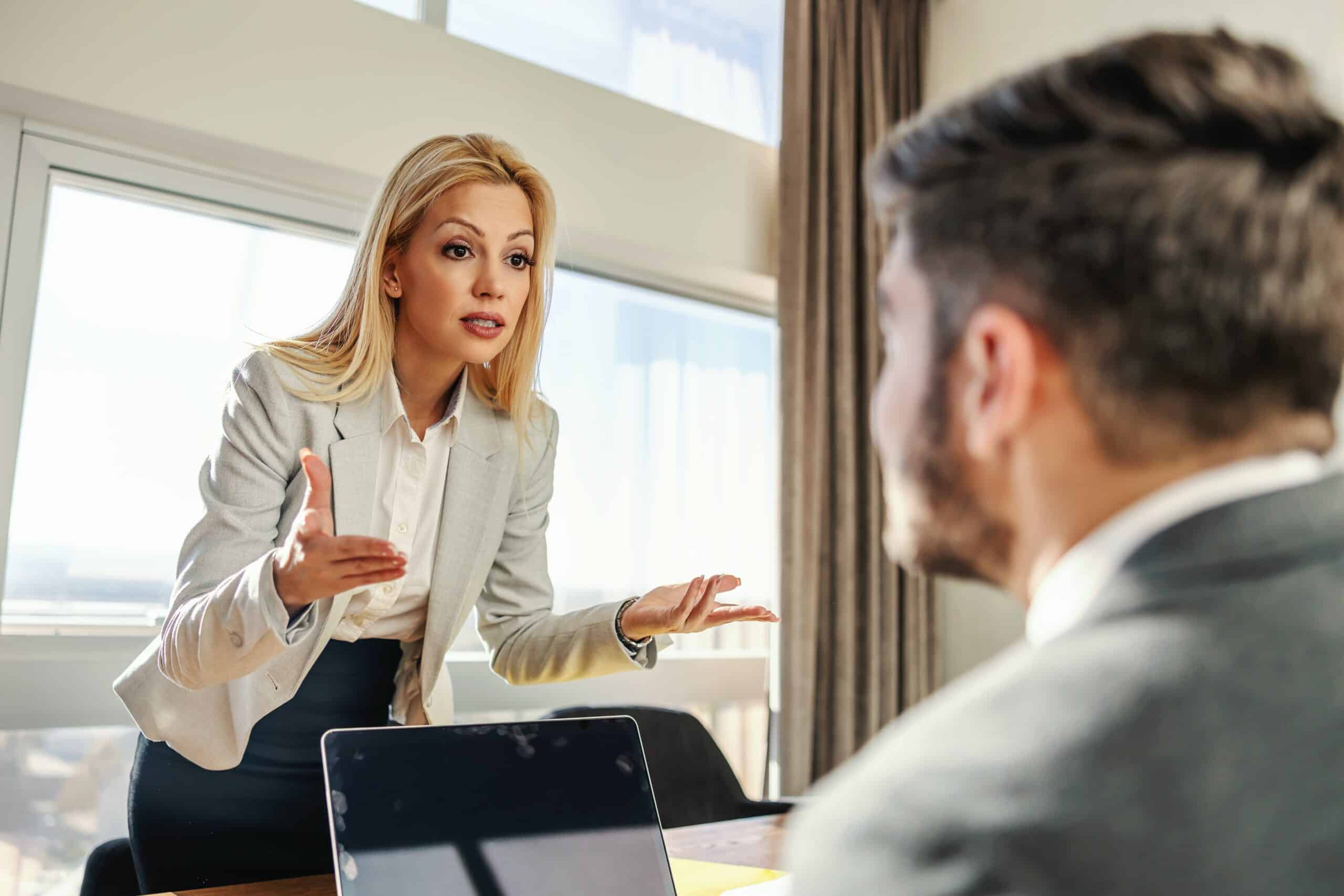 a blonde woman talking to a man