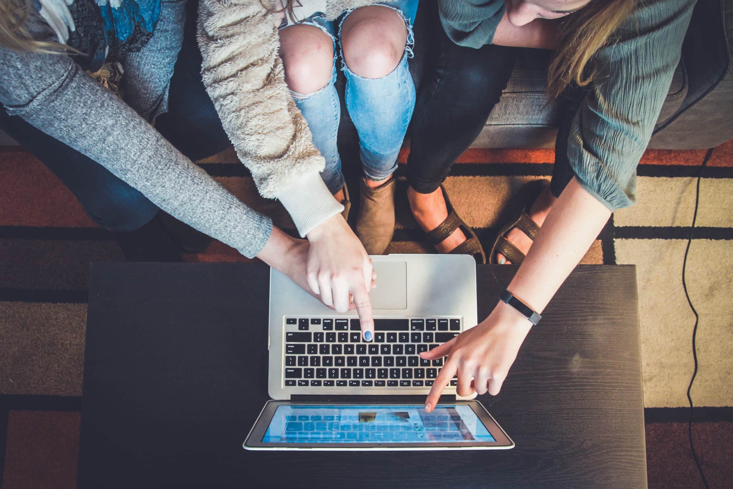 john-schnobrich-2FPjlAyMQTA-unsplash three person pointing in the laptop