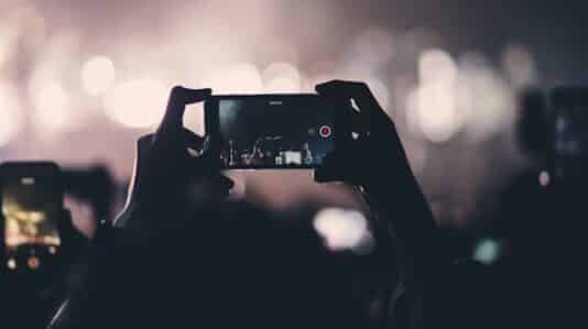 a person holding a phone and recording