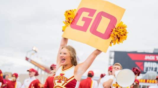 blonde cheerleader holding banner