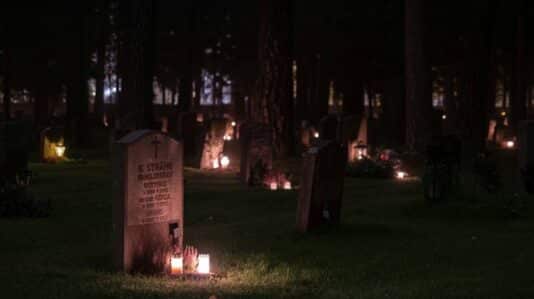 graveyard with small lighted candles