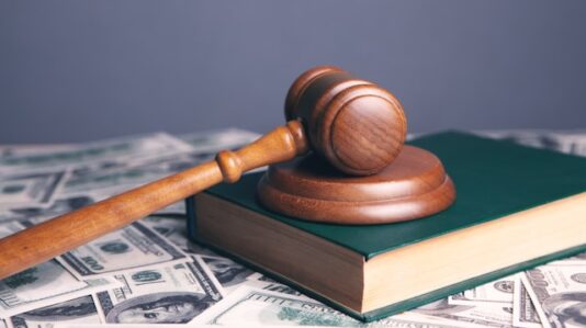 a wooden gavel on top of a book