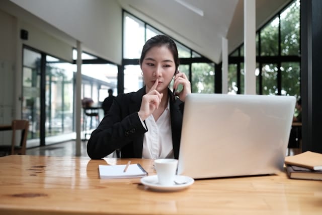 a woman putting her index finger on her lips for silence