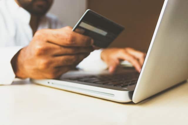 a man using a credit card to pay online