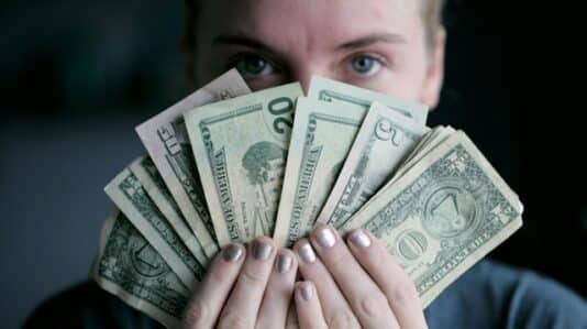 a woman holding money bills