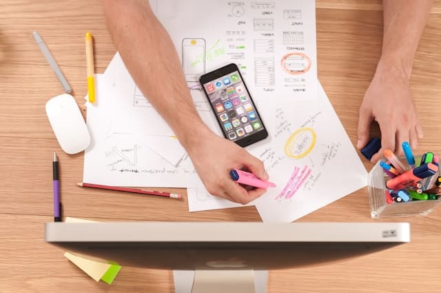 paper, pens and smart phone on the table