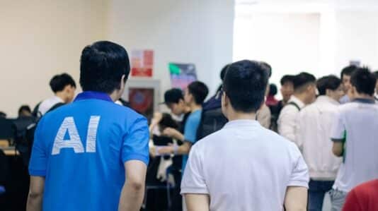 a man wearing blue shirt with 'AI' print at the back