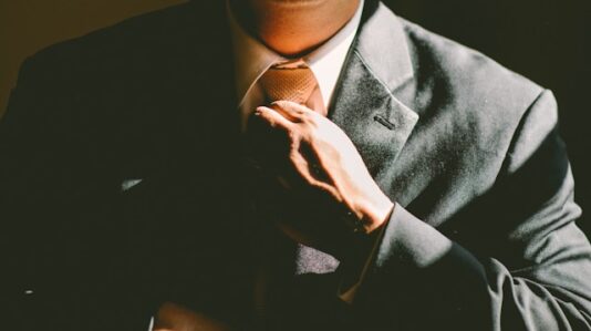 a man fixing his necktie