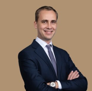 a man wearing a black suit and tie