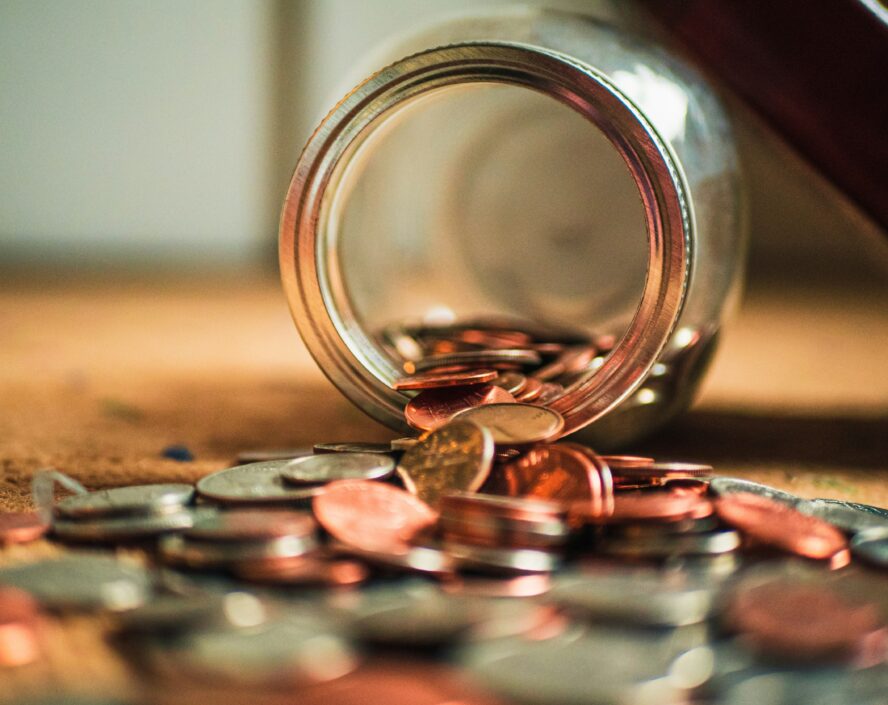 spilled coins from a glass jar