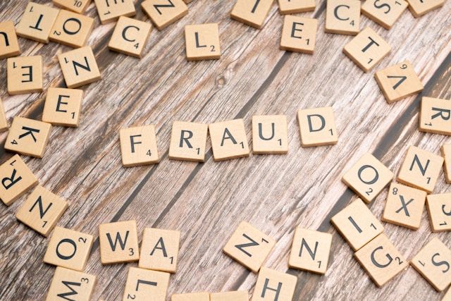 scrabble tiles formed the word 'fraud'