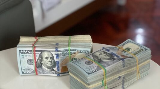 bundles of US dollar bills on a table