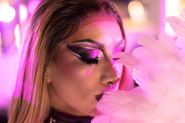 a woman in full make up, close eyes