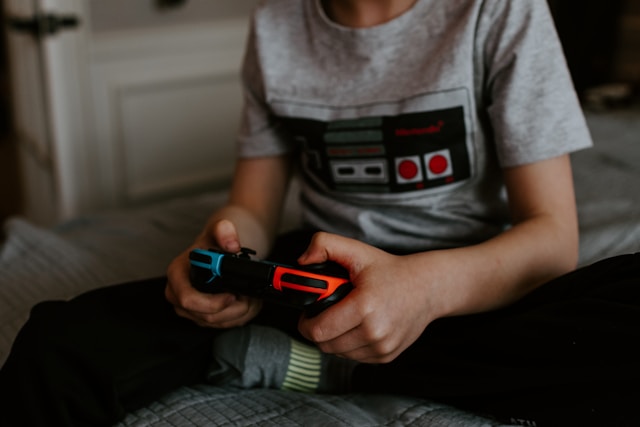 teenager holding a game controller