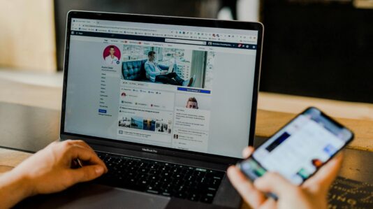 an open laptop showing a social media user profile