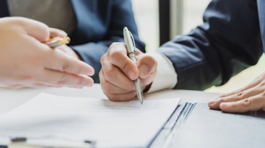 a man going to sign a document