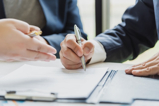 a man going to sign a document
