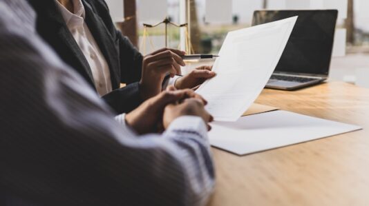 a document shown and being explained to another person
