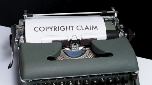 An old typewriter with a sheet of paper labeled copyright claim