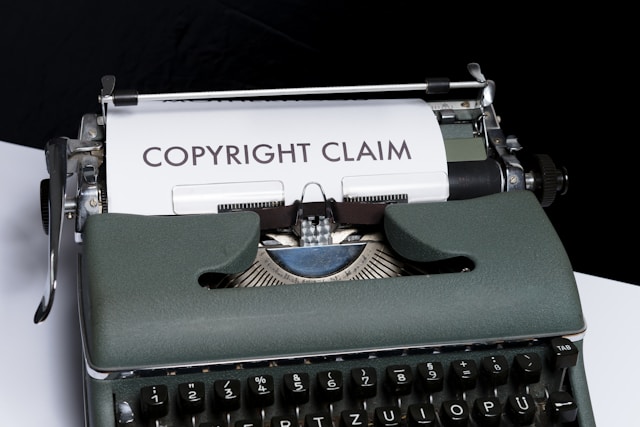 An old typewriter with a sheet of paper labeled copyright claim