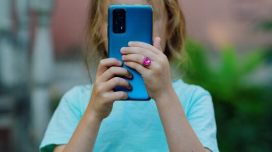 a kid holding a mobile phone