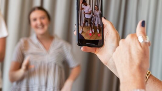 a person taking photo using a mobile phone