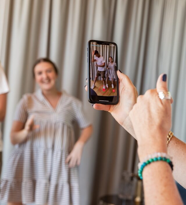 a person taking photo using a mobile phone