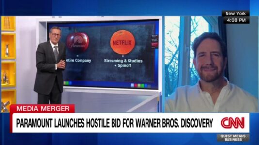 Domenic Romano in white shirt being interviewed in a CNN news tv program