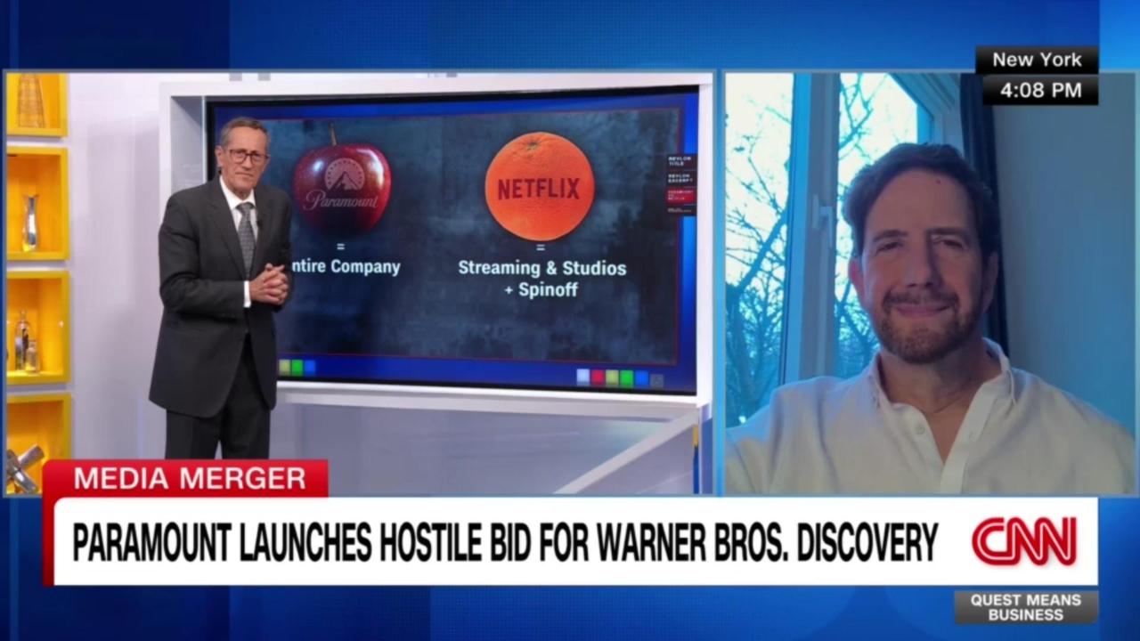 DR Paramount Hostile Takeover-Cover 2 Domenic Romano in white shirt being interviewed in a CNN news tv program