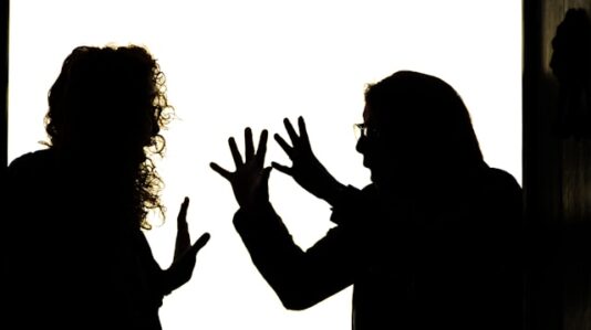 silhouette of two having arguments