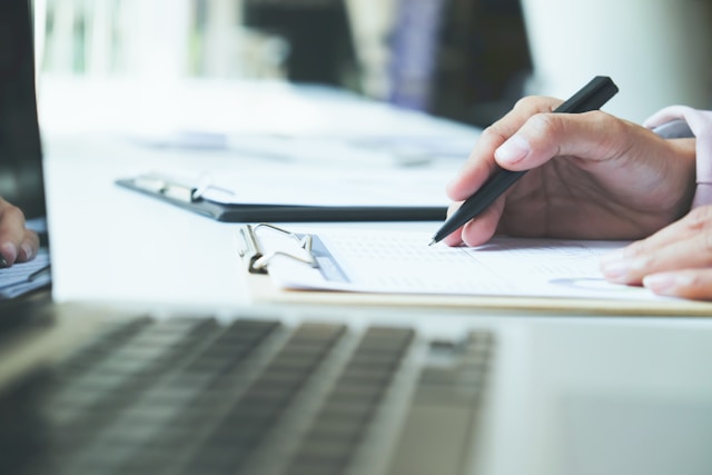 a keyboard and writing pad on a table