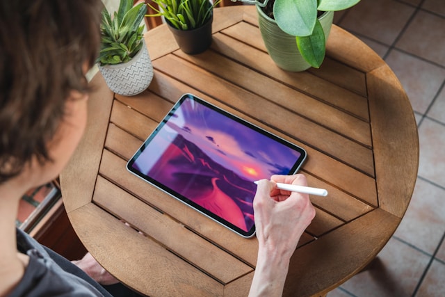 a man creating art using a electronic gadget
