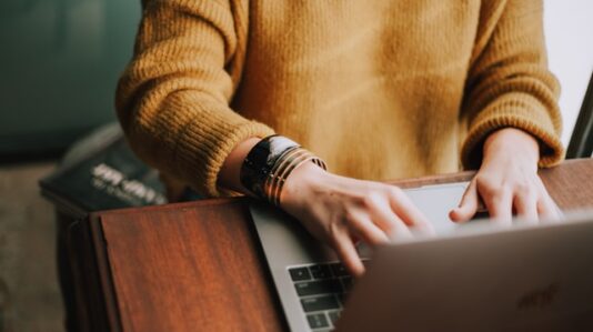 a person doing some work on a laptop