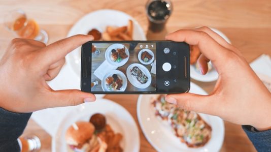 a person snapping food on the table