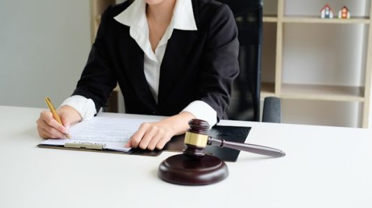 a woman going to sign a document
