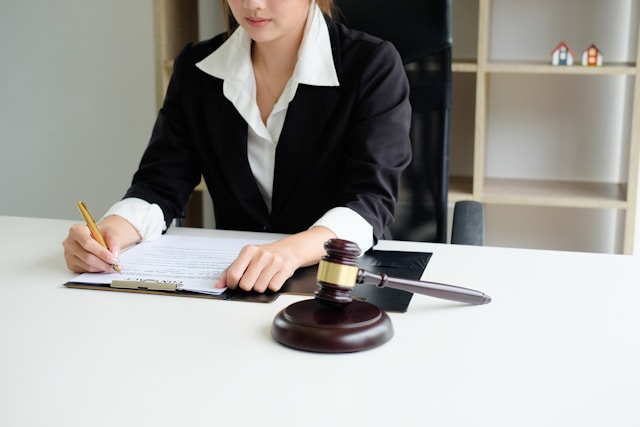a woman going to sign a document