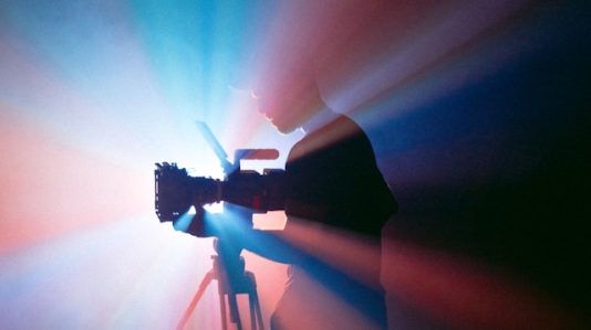 a cameran man in silhouette