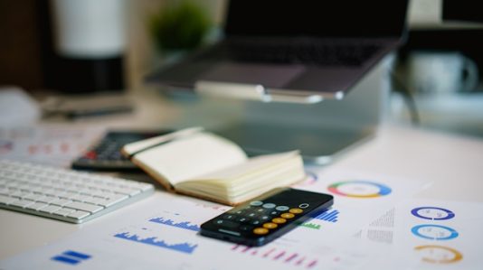 calculator, keyboard, small notebook on the table