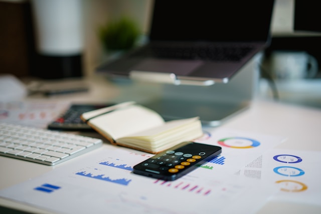 calculator, keyboard, small notebook on the table