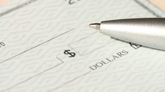 a blank cheque and ballpen